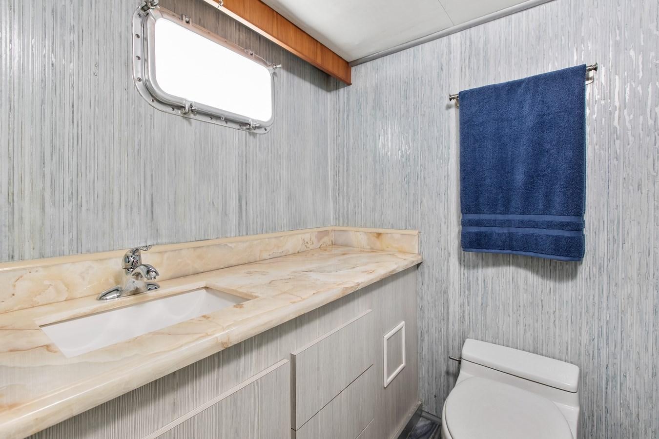 a bathroom with a sink and a toilet aboard TRES HERMANOS VI Yacht for Sale