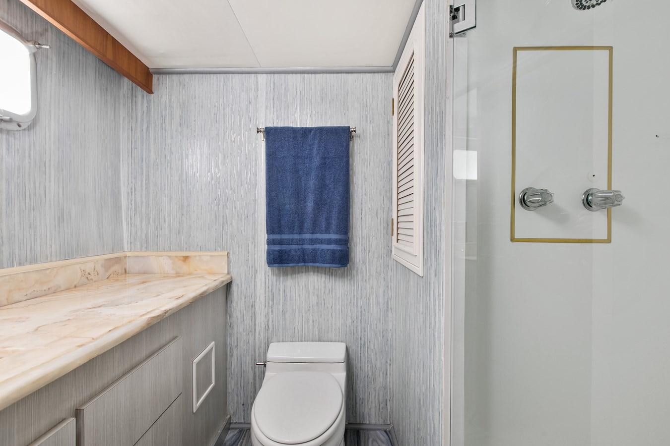 a bathroom with a toilet and a sink aboard TRES HERMANOS VI Yacht for Sale