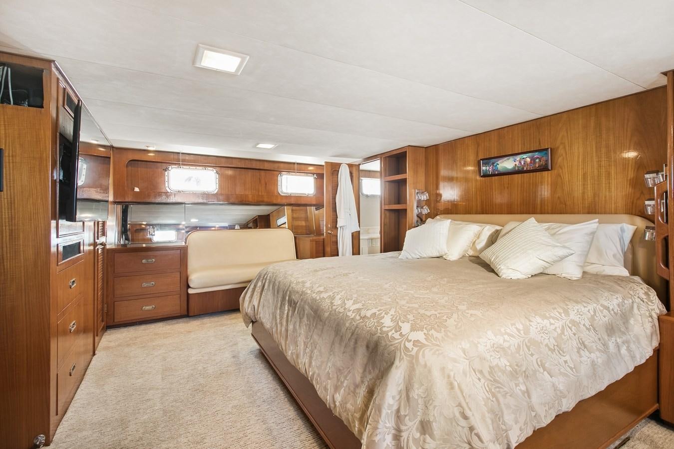a bedroom with a bed and a desk aboard TRES HERMANOS VI Yacht for Sale