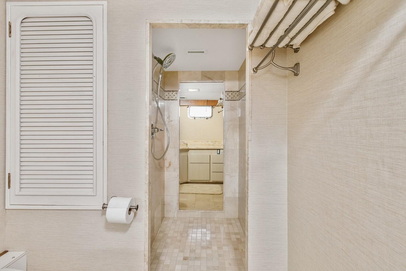 a bathroom with a shower and a sink aboard TRES HERMANOS VI Yacht for Sale