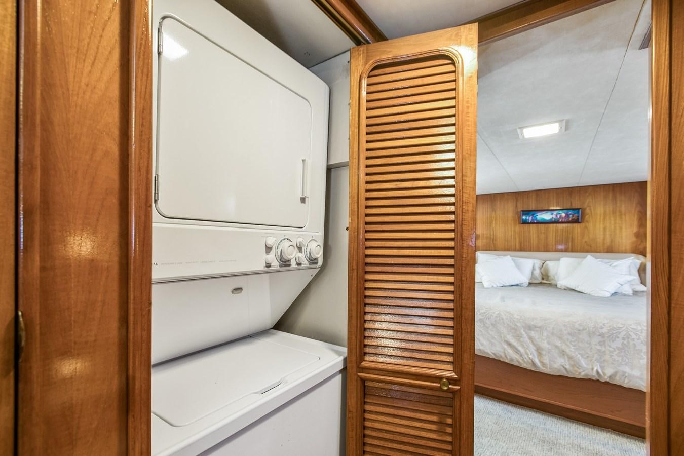 a closet with a bed and a dresser aboard TRES HERMANOS VI Yacht for Sale