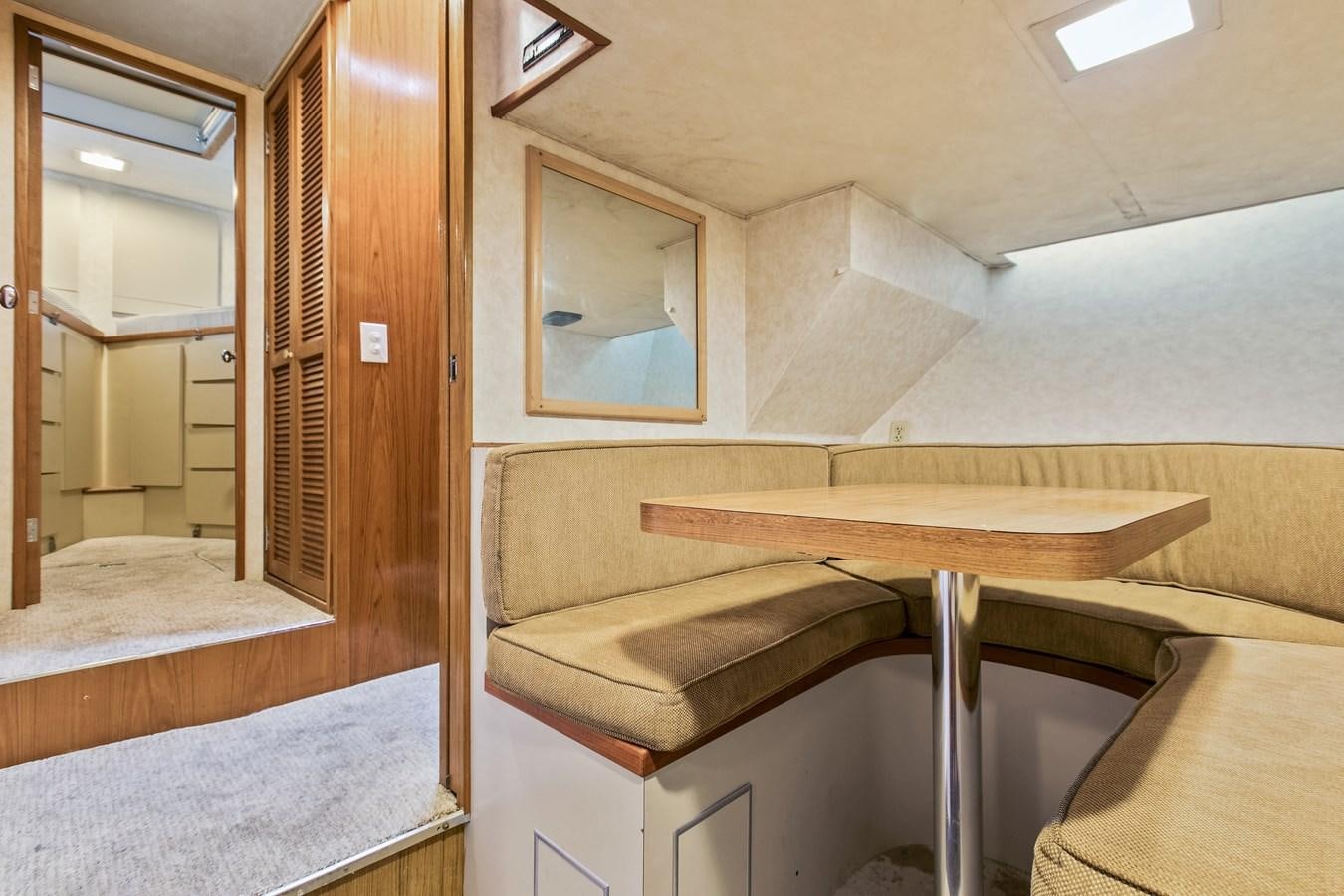 a room with a table and a couch aboard TRES HERMANOS VI Yacht for Sale