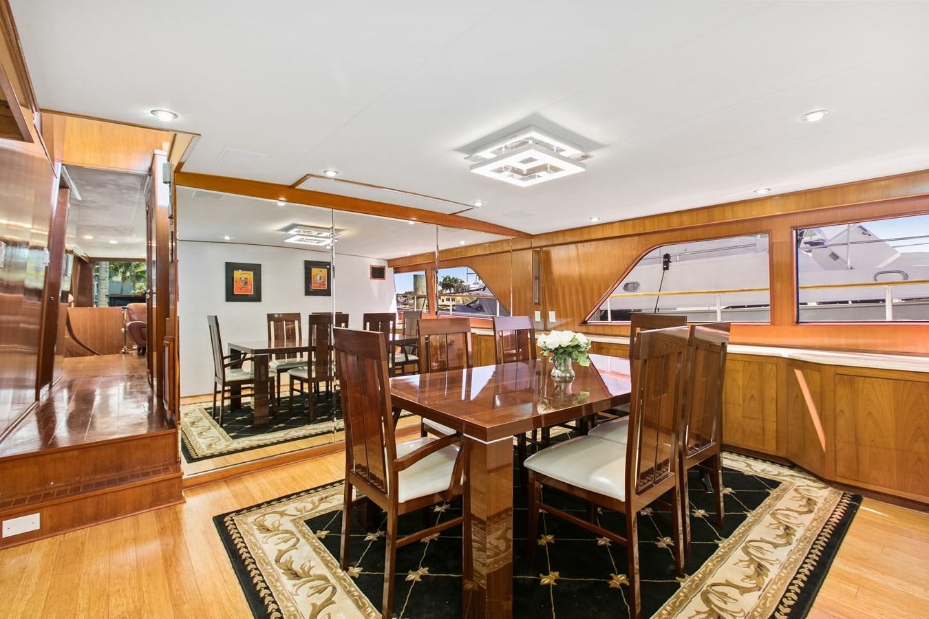 a dining room with a table and chairs aboard TRES HERMANOS VI Yacht for Sale