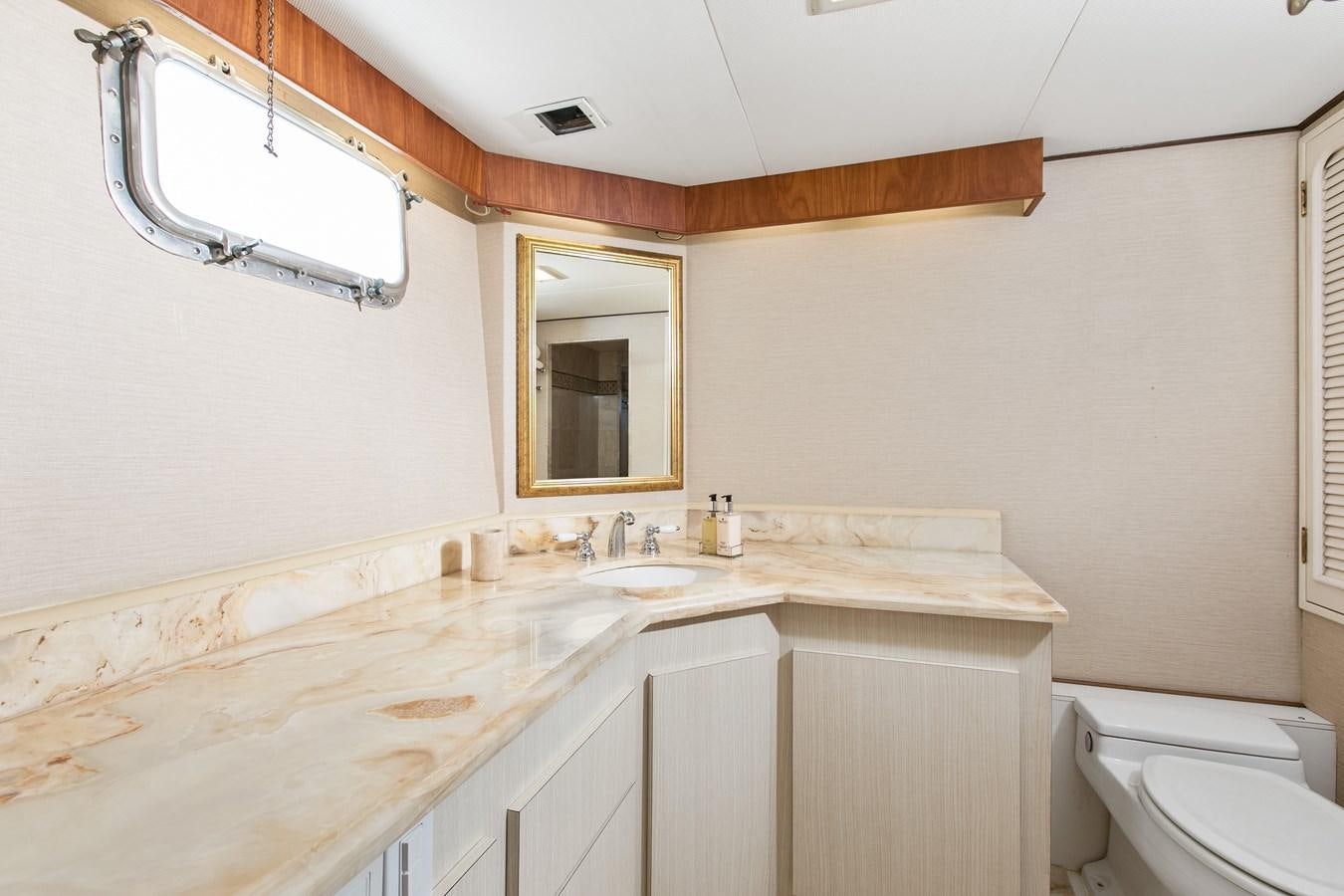 a bathroom with a sink and a mirror aboard TRES HERMANOS VI Yacht for Sale