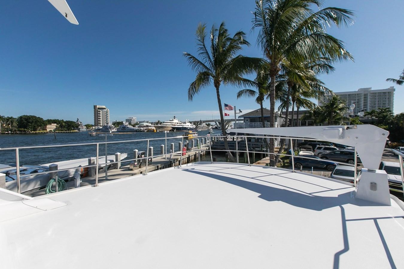 a pool with a beach and palm trees in the background aboard TRES HERMANOS VI Yacht for Sale