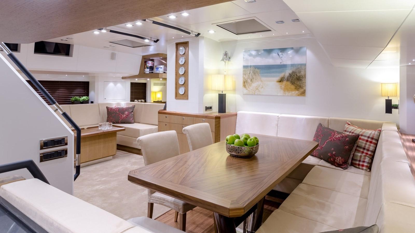 a living room with a table and couches aboard BELLKARA Yacht for Sale