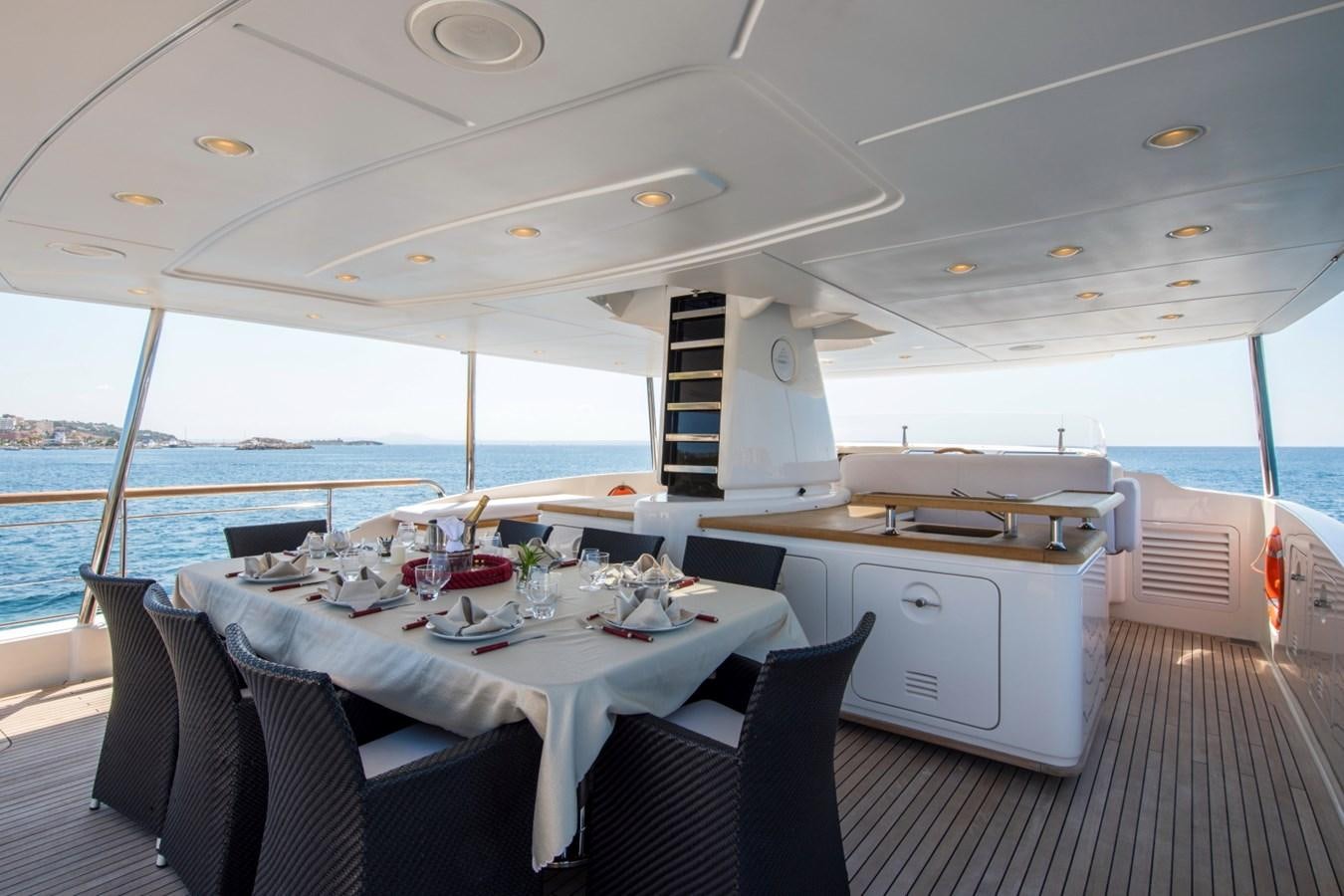 a boat with a table and chairs aboard MAI Yacht for Sale