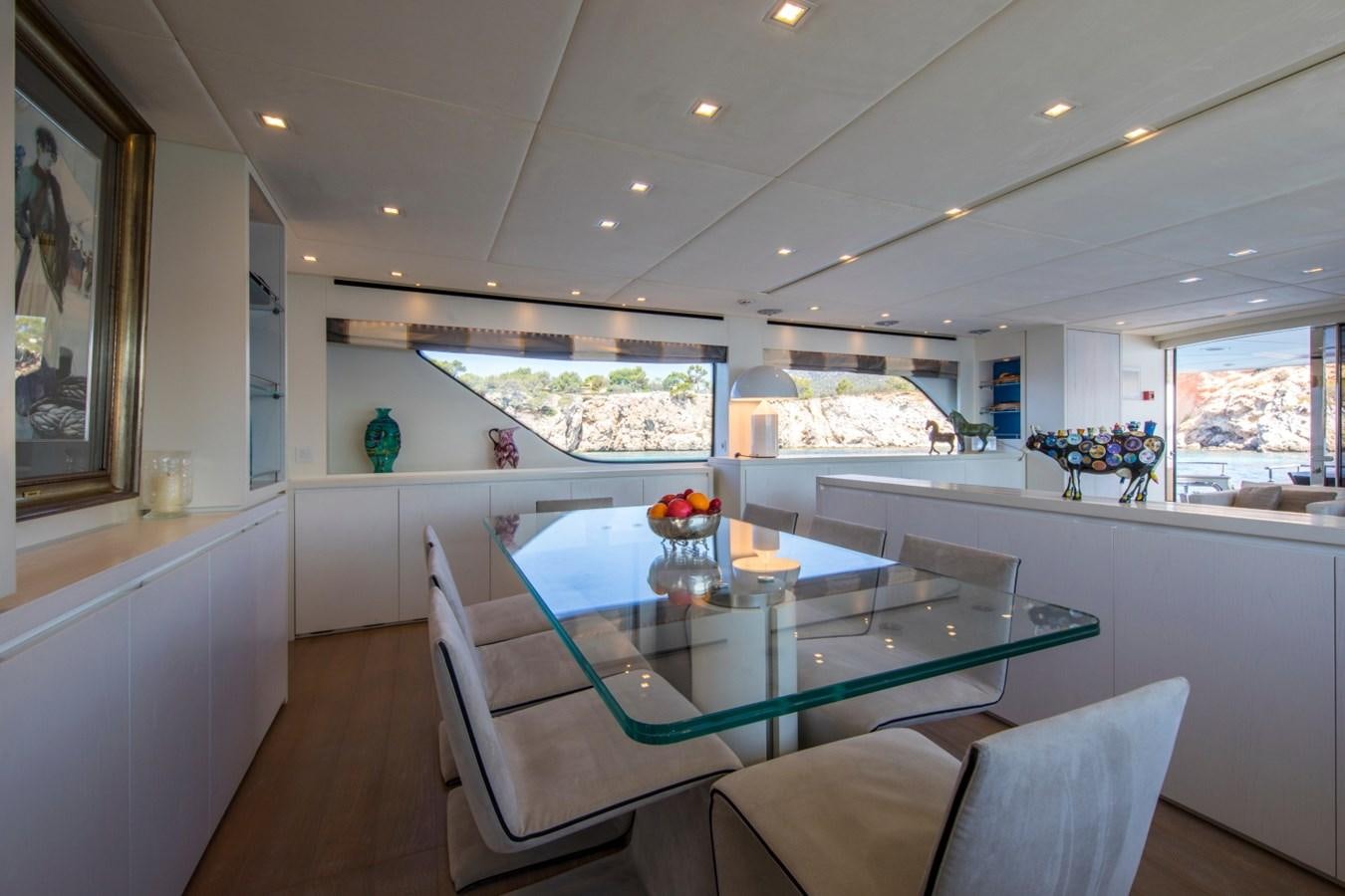 a modern looking kitchen with a large table and chairs aboard MAI Yacht for Sale