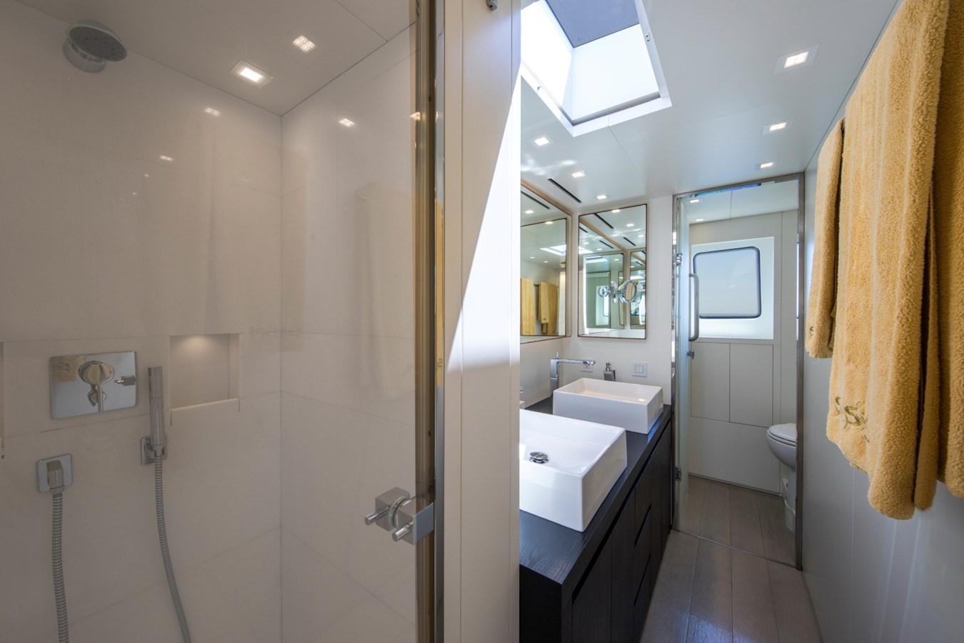 a bathroom with a shower and sinks aboard MAI Yacht for Sale