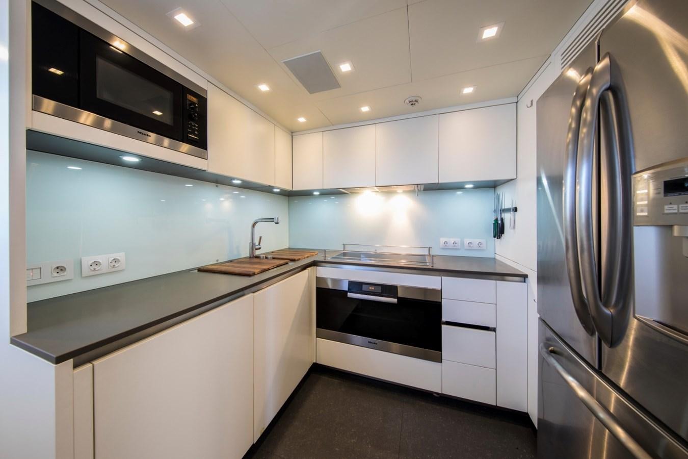 a kitchen with white cabinets aboard MAI Yacht for Sale