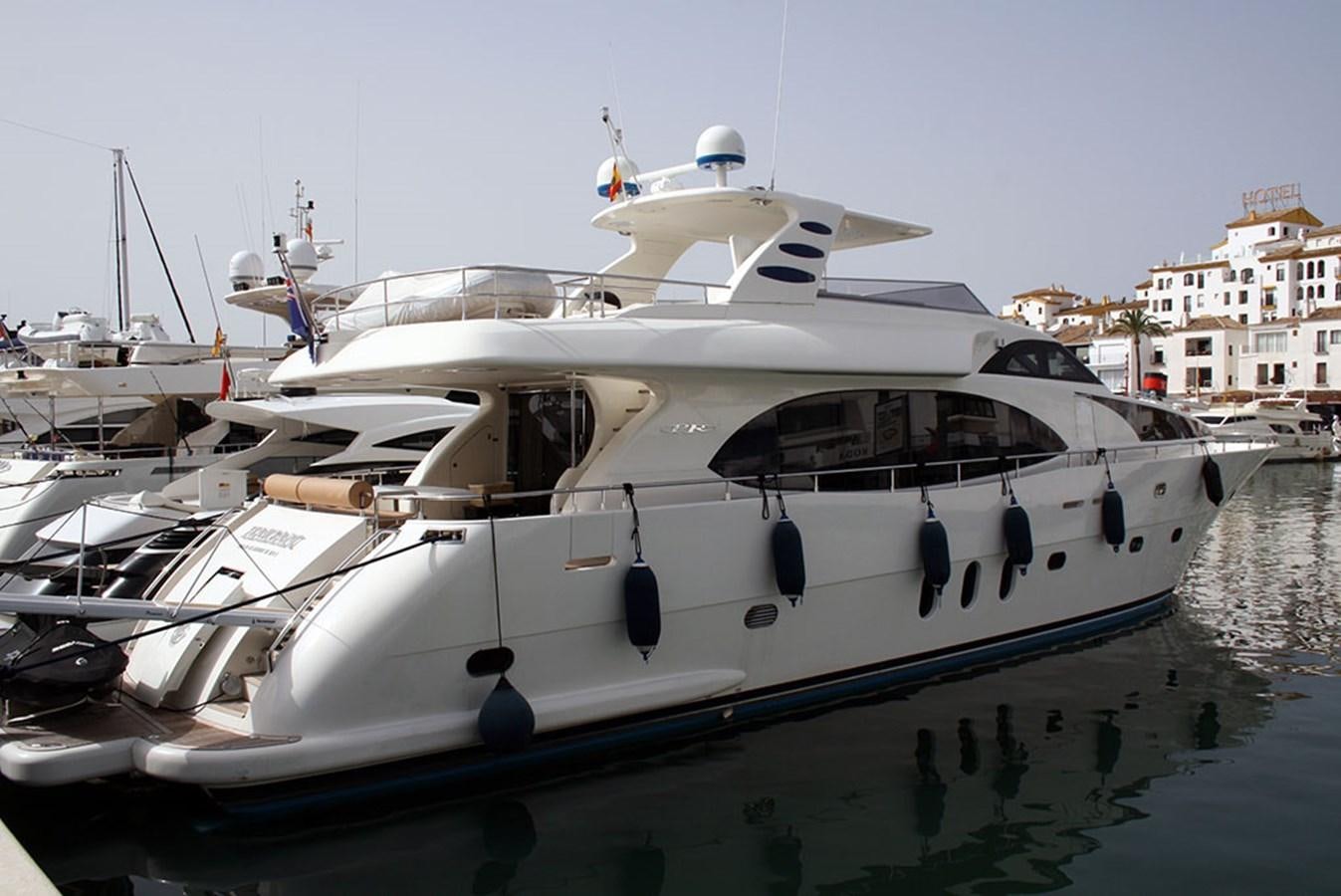 a white yacht in a harbor aboard HAIGAN Yacht for Sale
