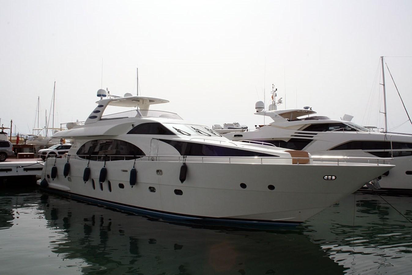 a white yacht in the water with USS Potomac (AG-25) in the background aboard HAIGAN Yacht for Sale
