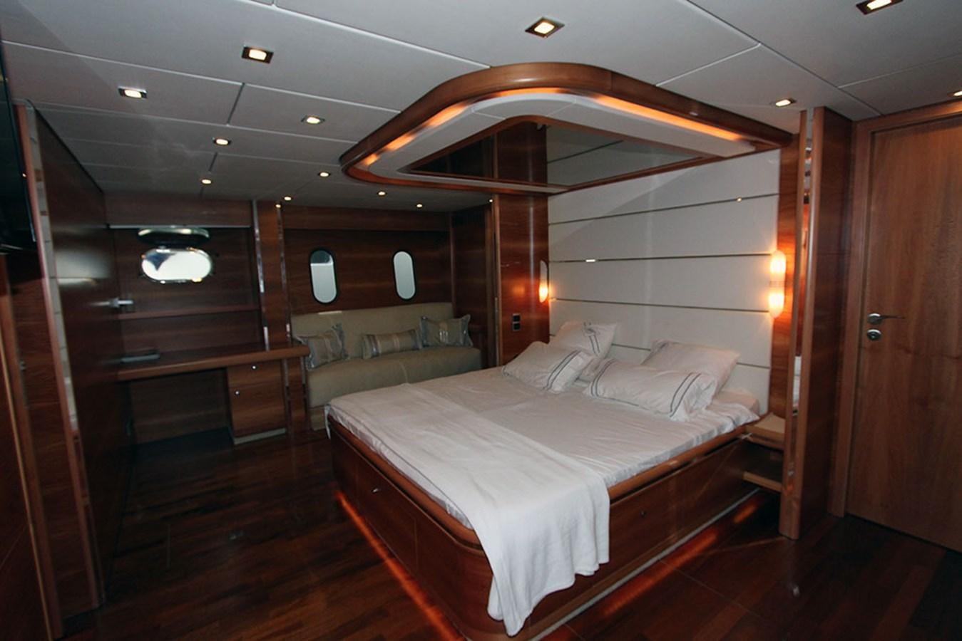 a room with a bed and a wood door aboard HAIGAN Yacht for Sale