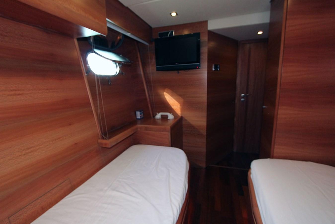 a room with a bed and a television on the wall aboard HAIGAN Yacht for Sale