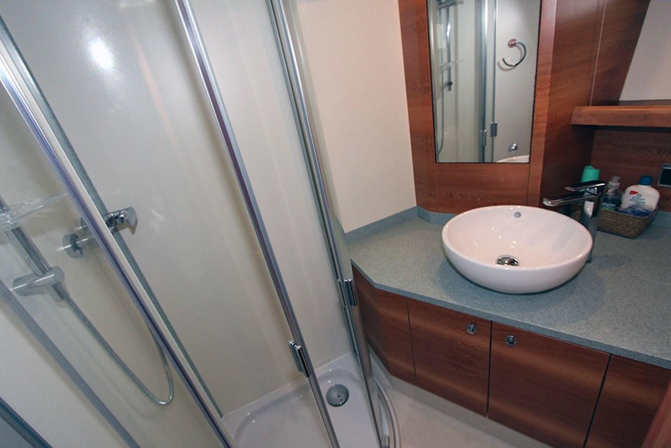 a bathroom with a glass shower aboard HAIGAN Yacht for Sale