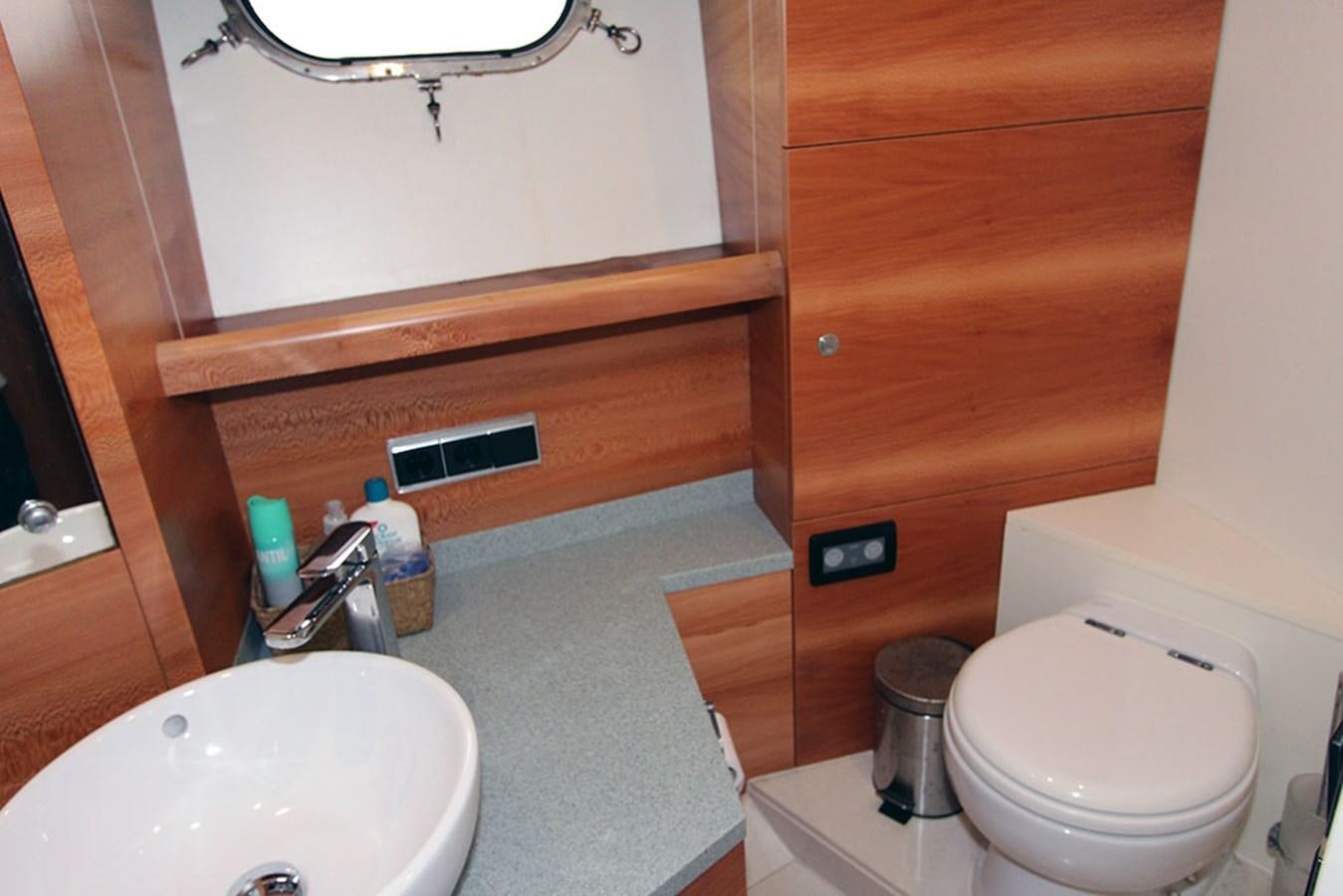 a bathroom with a toilet and a sink aboard HAIGAN Yacht for Sale