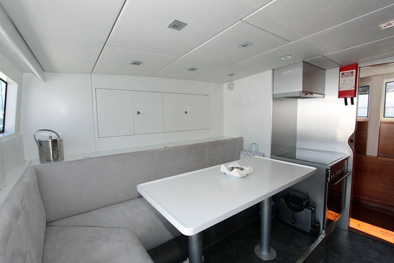 a room with a table and chairs aboard HAIGAN Yacht for Sale
