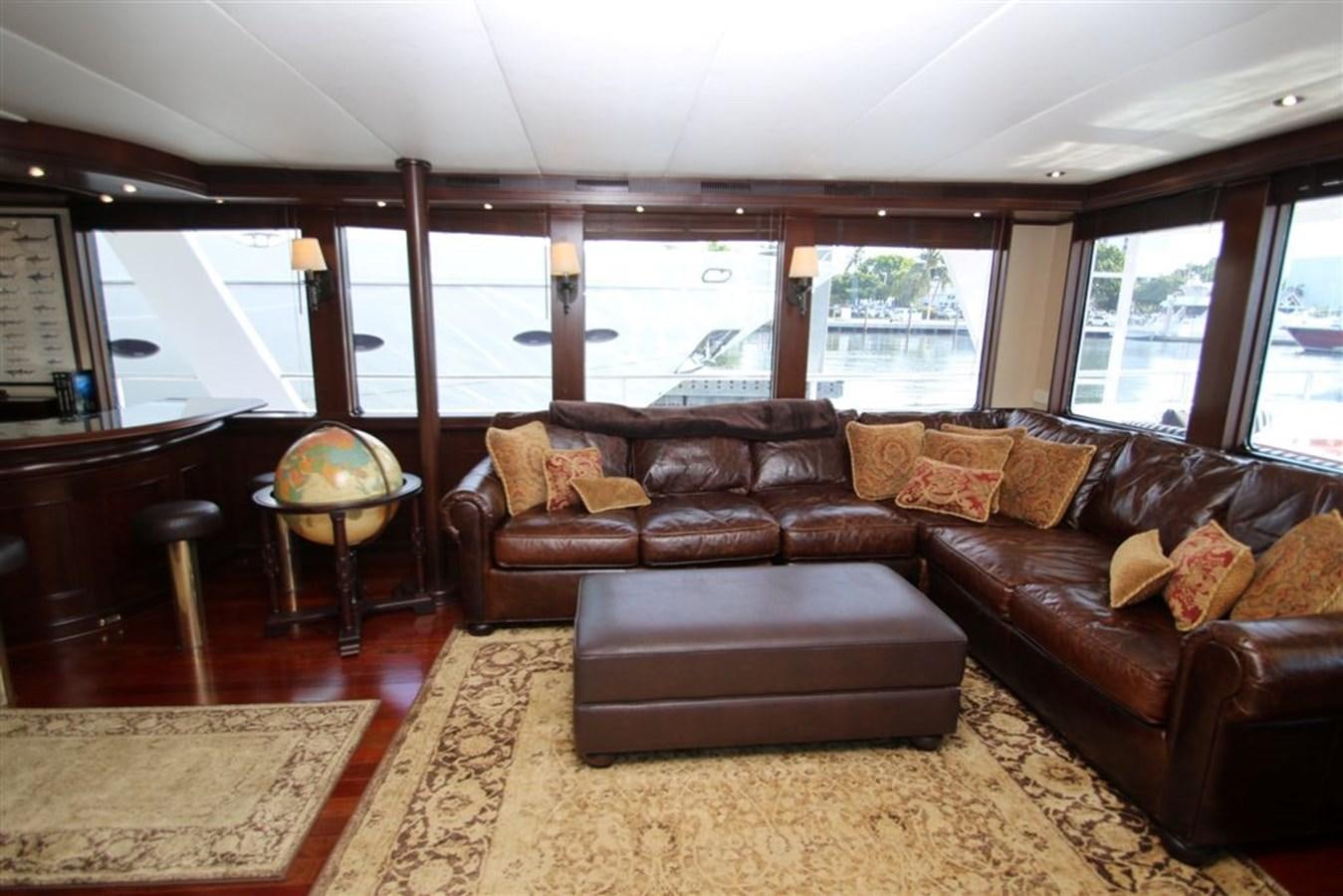 a living room with leather couches aboard ROSA Yacht for Sale