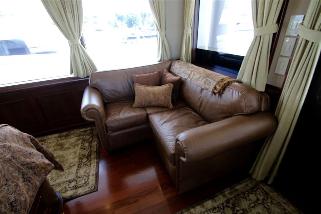 a couch in a living room aboard ROSA Yacht for Sale