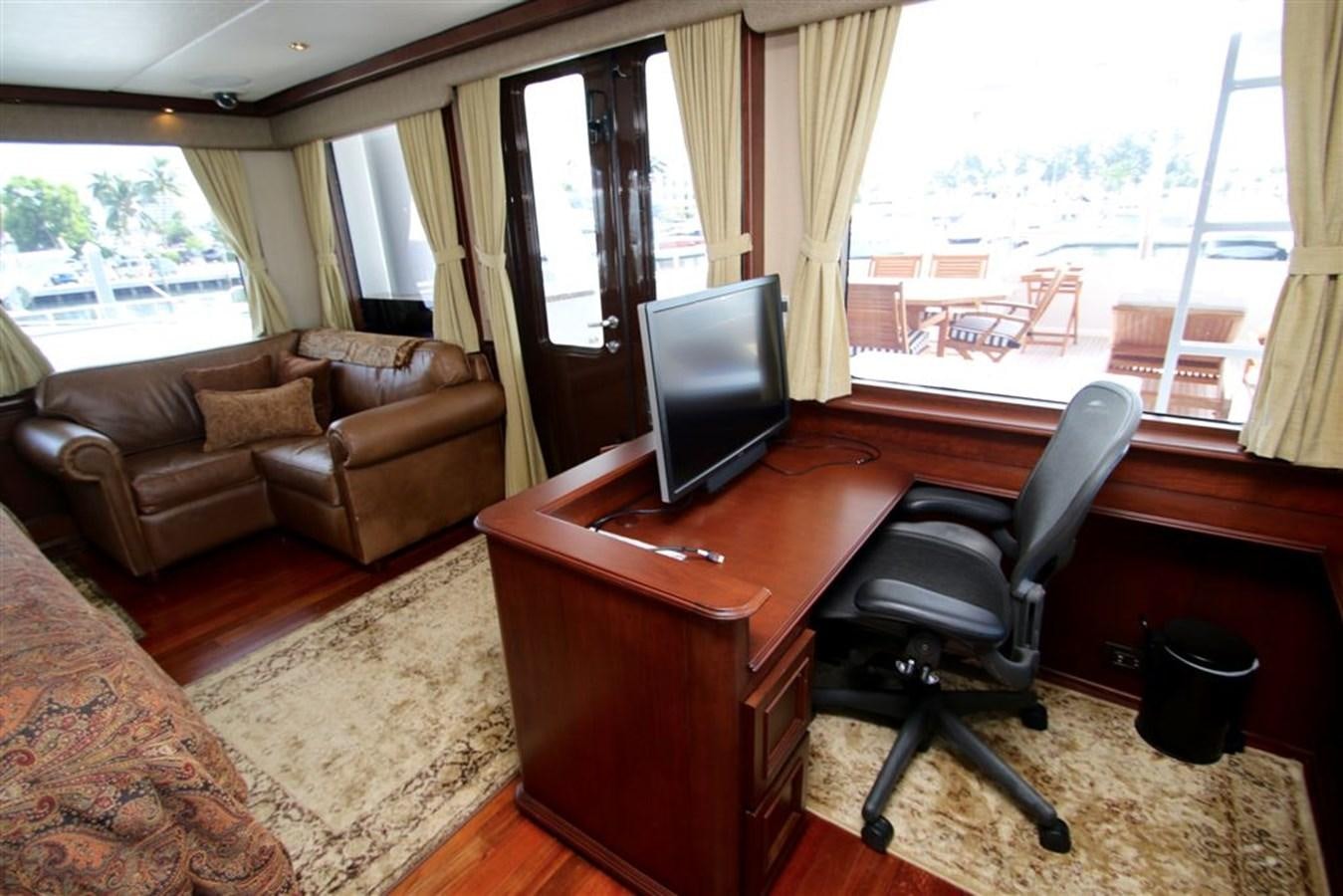 a living room with a desk and a tv aboard ROSA Yacht for Sale