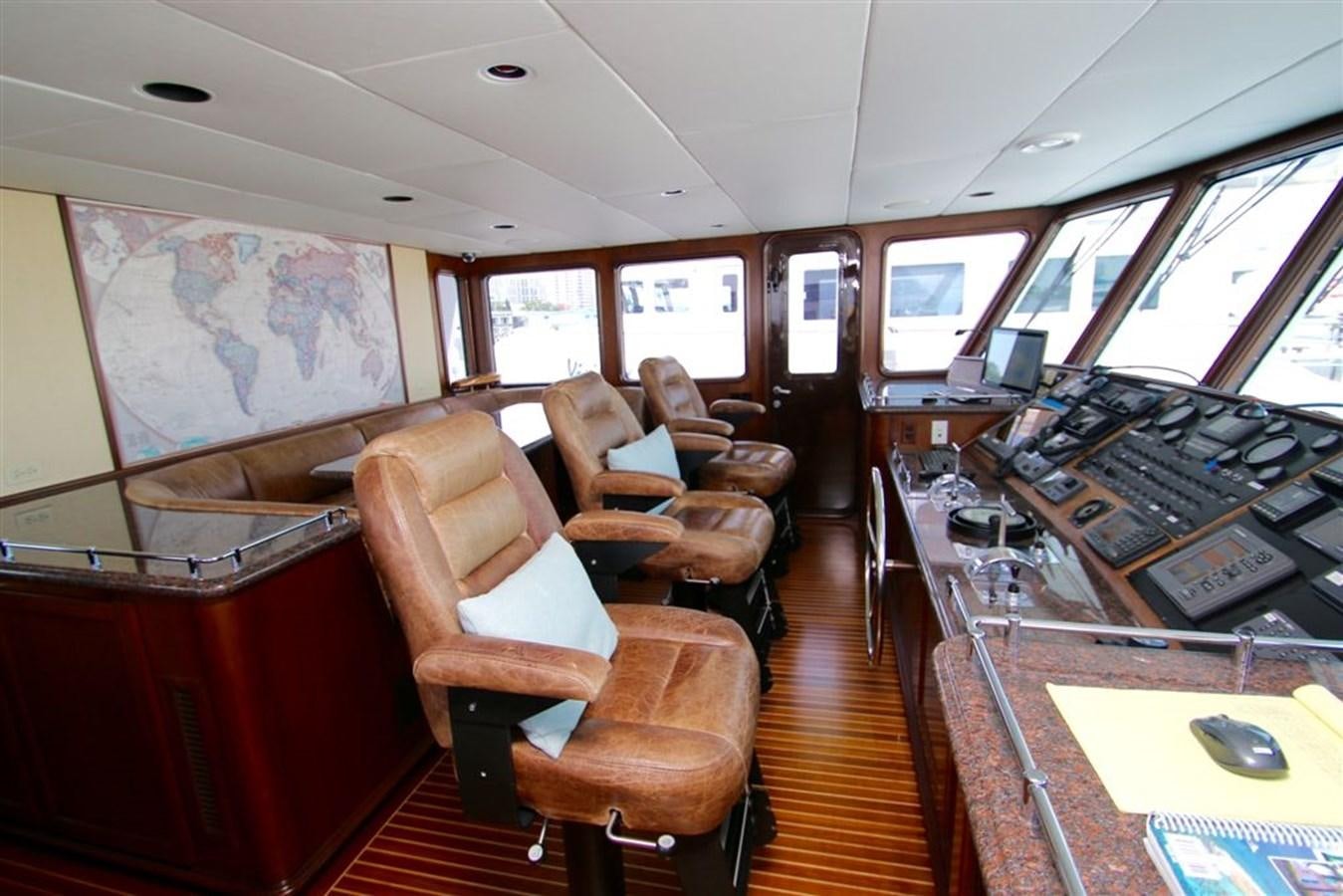 inside of a vehicle with a desk and chairs aboard ROSA Yacht for Sale