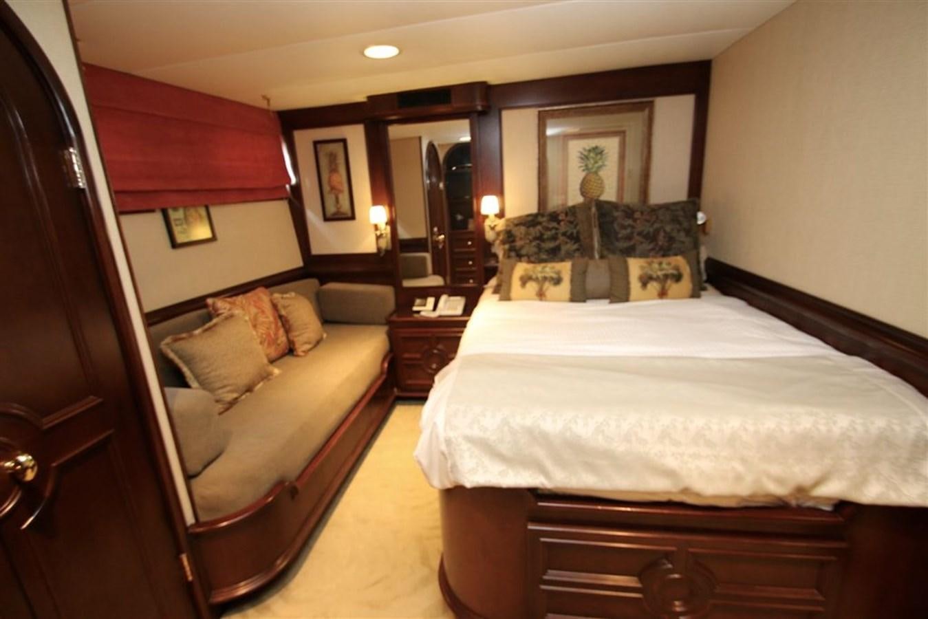a bedroom with a bed and a couch aboard ROSA Yacht for Sale
