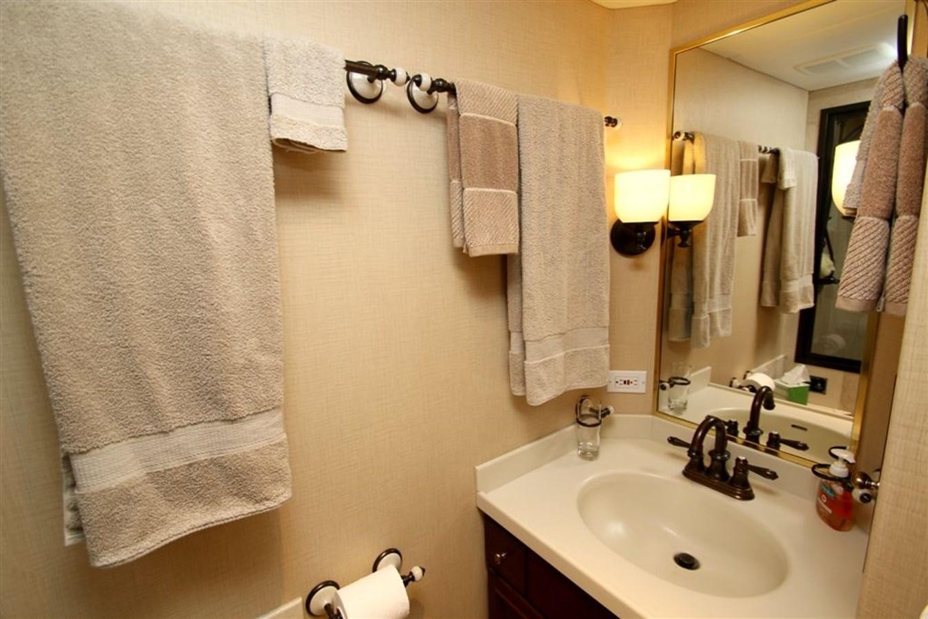 a bathroom with towels on the wall aboard ROSA Yacht for Sale