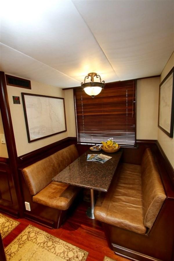 a living room with a table and couches aboard ROSA Yacht for Sale