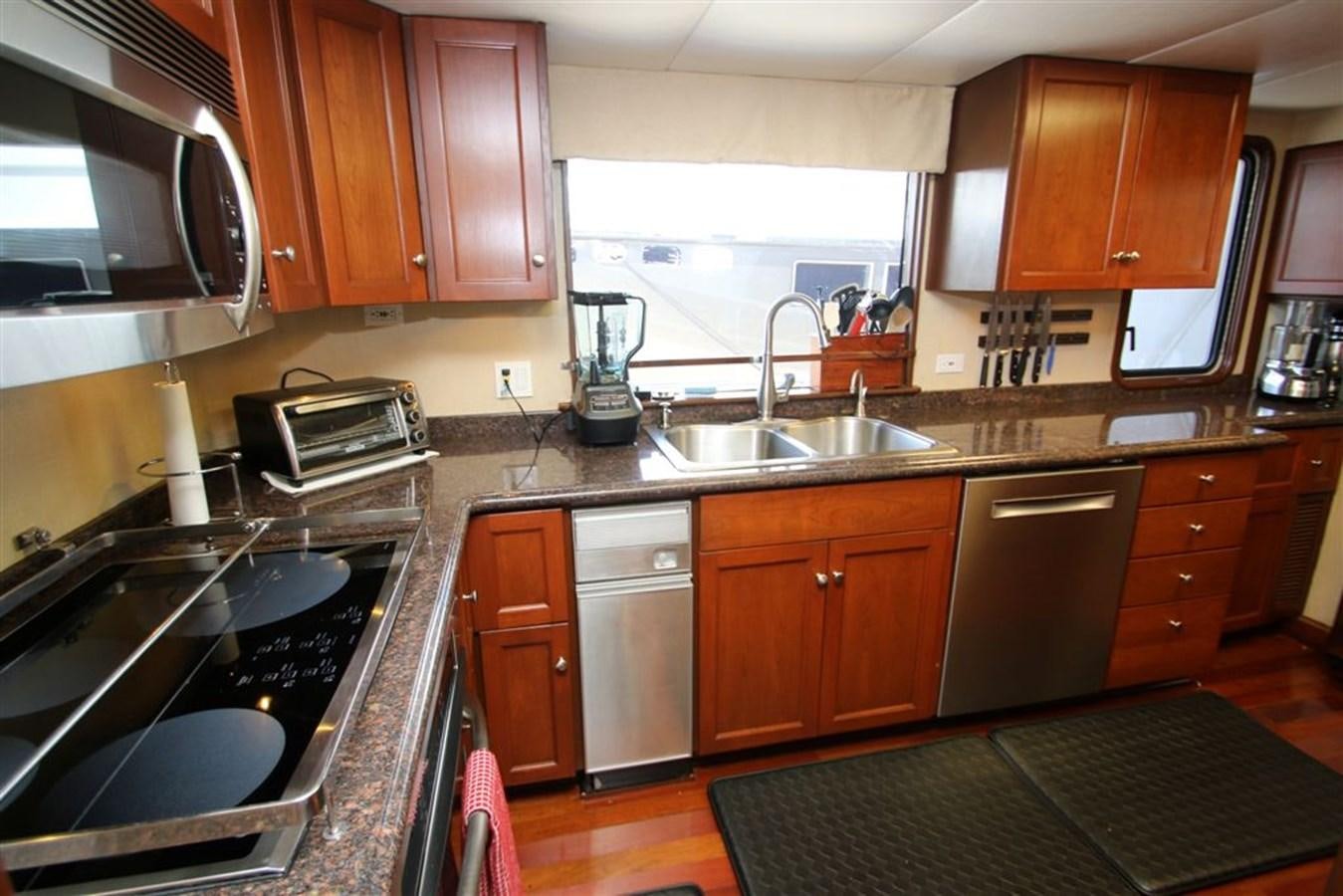 a kitchen with wooden cabinets aboard ROSA Yacht for Sale