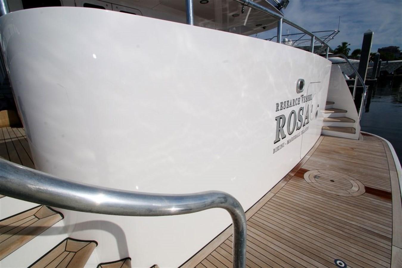 a white boat on a dock aboard ROSA Yacht for Sale