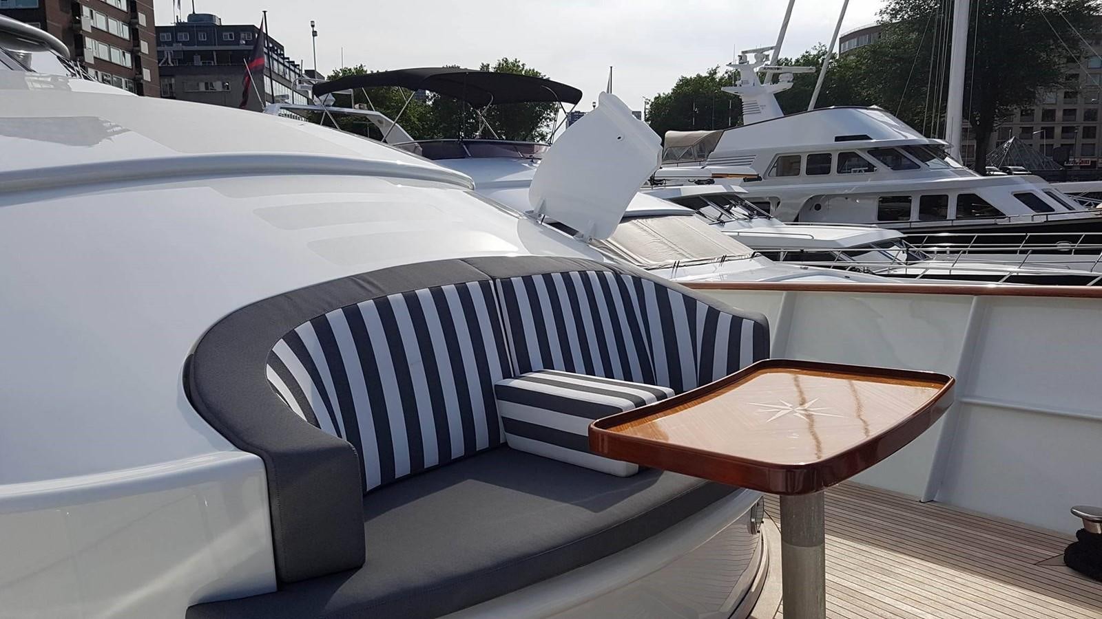 a deck with a chair and a table on it aboard LADY MIKKI Yacht for Sale