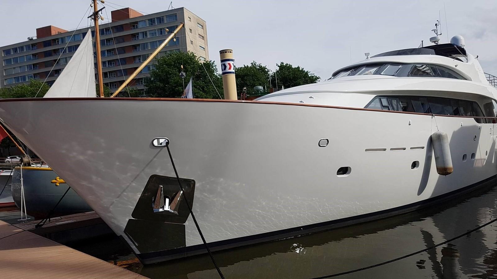a white yacht in a harbor aboard LADY MIKKI Yacht for Sale