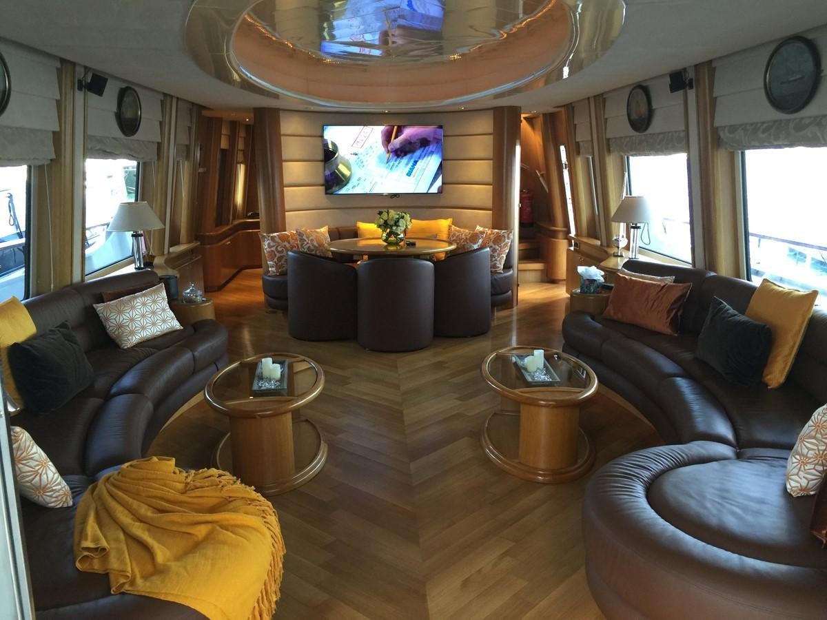 a living room with a fireplace aboard LADY MIKKI Yacht for Sale