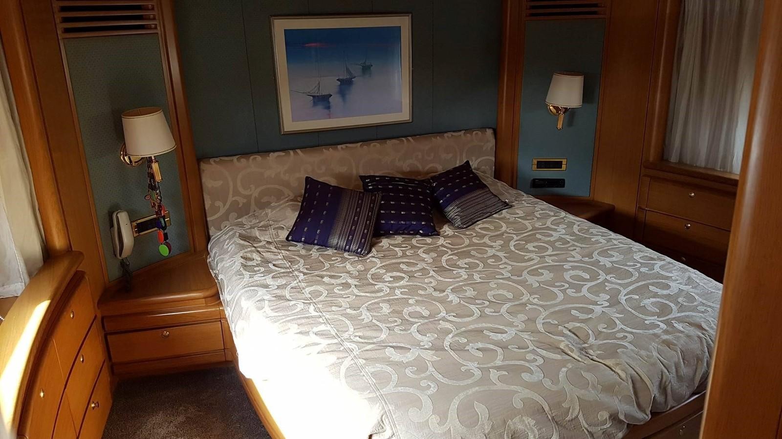 a bed with white sheets aboard LADY MIKKI Yacht for Sale