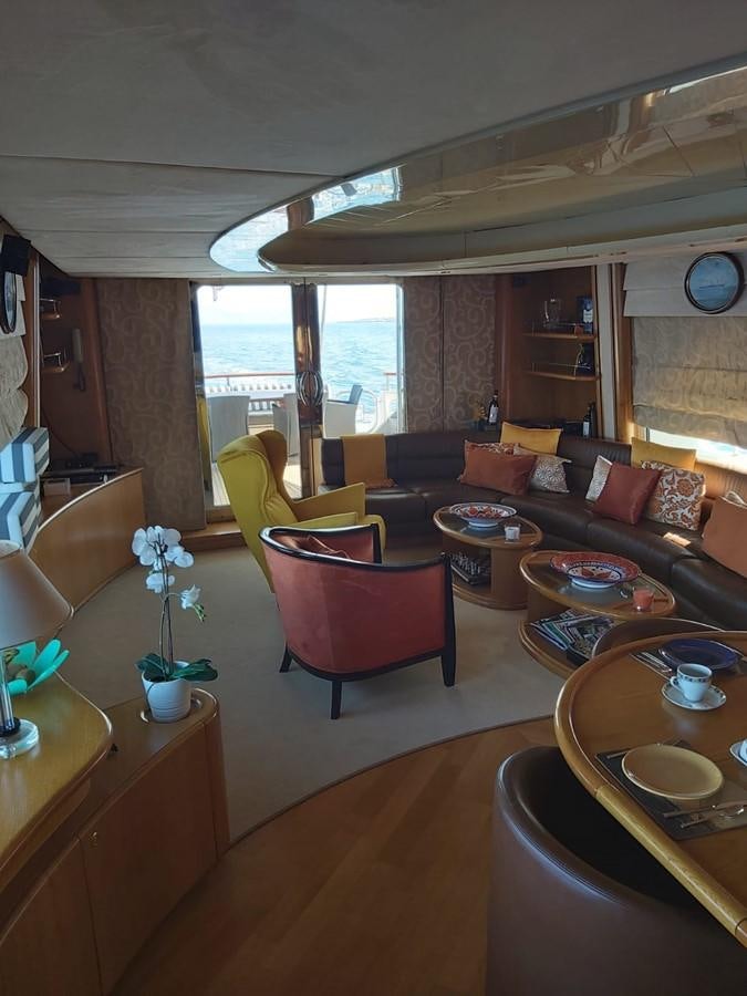 a living room with a couch and a table aboard LADY MIKKI Yacht for Sale