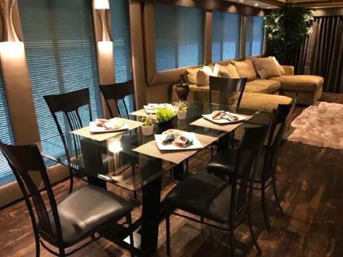 a dining table set for a meal aboard FANTASY HOUSEBOAT Yacht for Sale