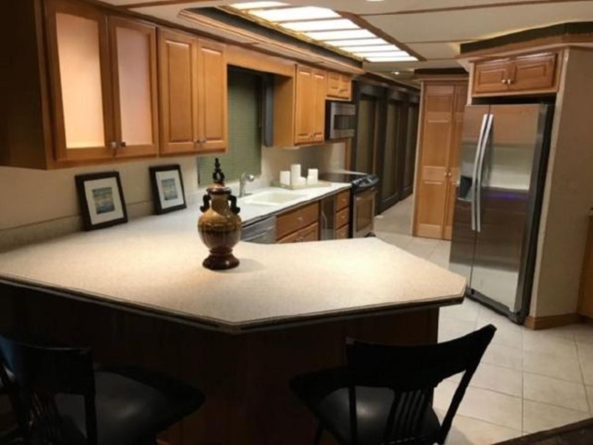 a kitchen with a statue aboard FANTASY HOUSEBOAT Yacht for Sale