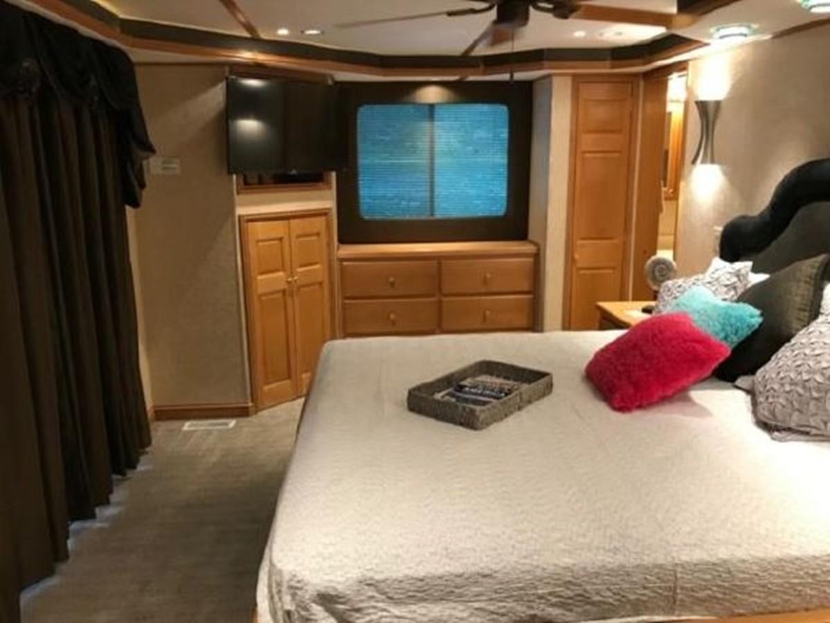a hotel room with a bed and tv aboard FANTASY HOUSEBOAT Yacht for Sale