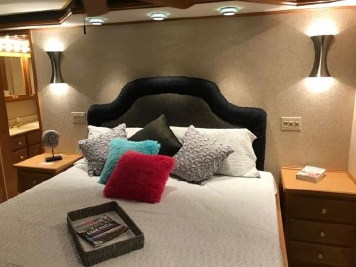 a bed with pillows and pillows aboard FANTASY HOUSEBOAT Yacht for Sale