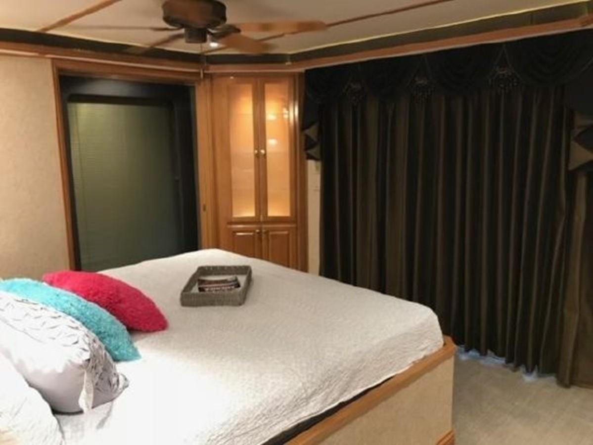 a bed with a phone on it aboard FANTASY HOUSEBOAT Yacht for Sale