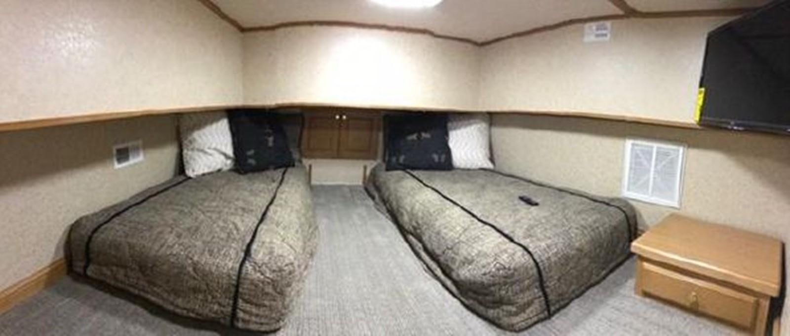 a room with a bed and a table aboard FANTASY HOUSEBOAT Yacht for Sale