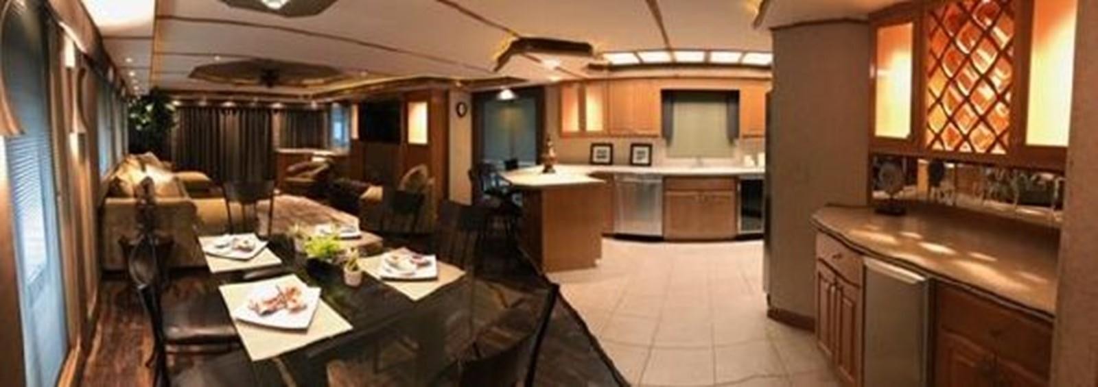 a kitchen and dining area aboard FANTASY HOUSEBOAT Yacht for Sale