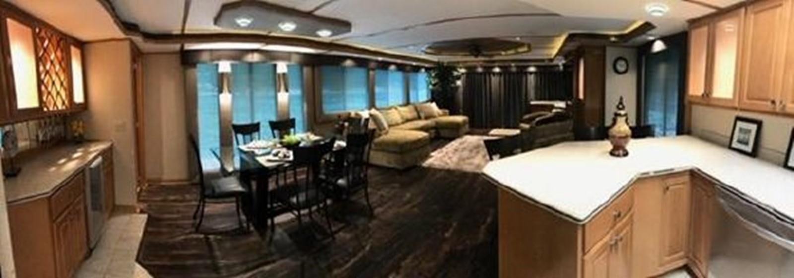 a large room with a table and chairs aboard FANTASY HOUSEBOAT Yacht for Sale