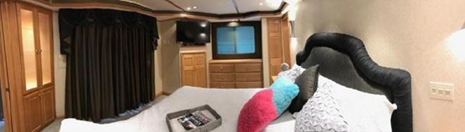 a bedroom with a bed and a tv aboard FANTASY HOUSEBOAT Yacht for Sale