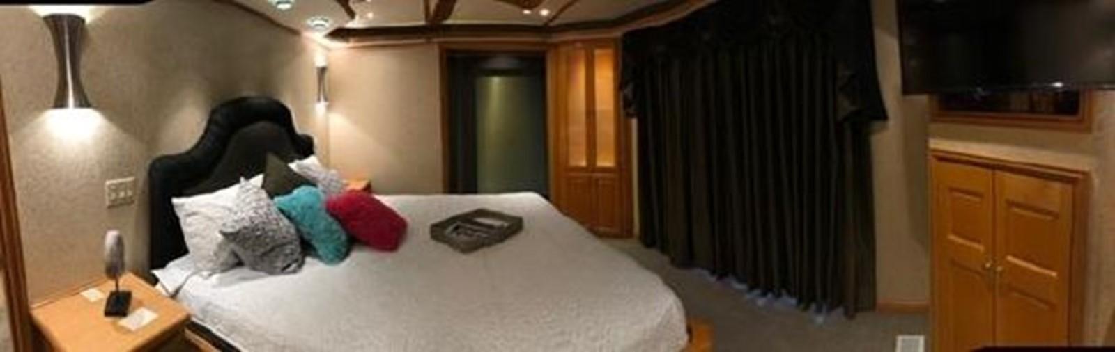 a room with a bed and a desk aboard FANTASY HOUSEBOAT Yacht for Sale