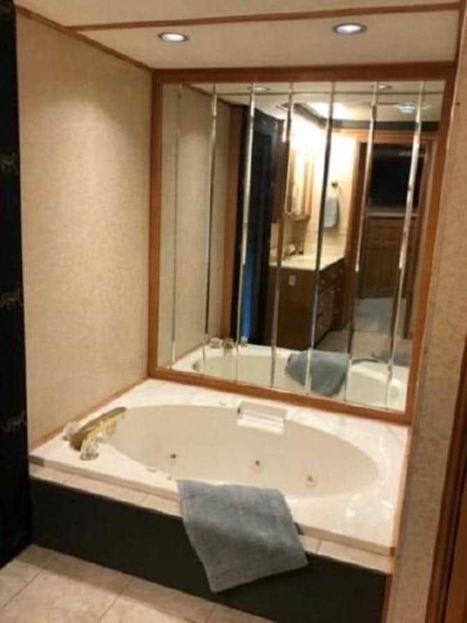 a bathroom with a large mirror aboard FANTASY HOUSEBOAT Yacht for Sale