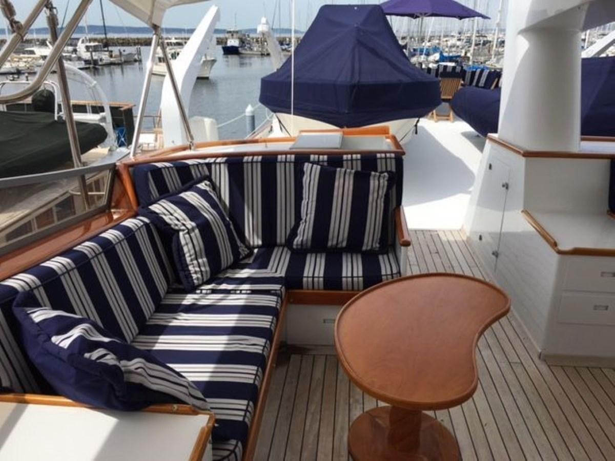 a boat with a chair and umbrella aboard ALEXIS Yacht for Sale