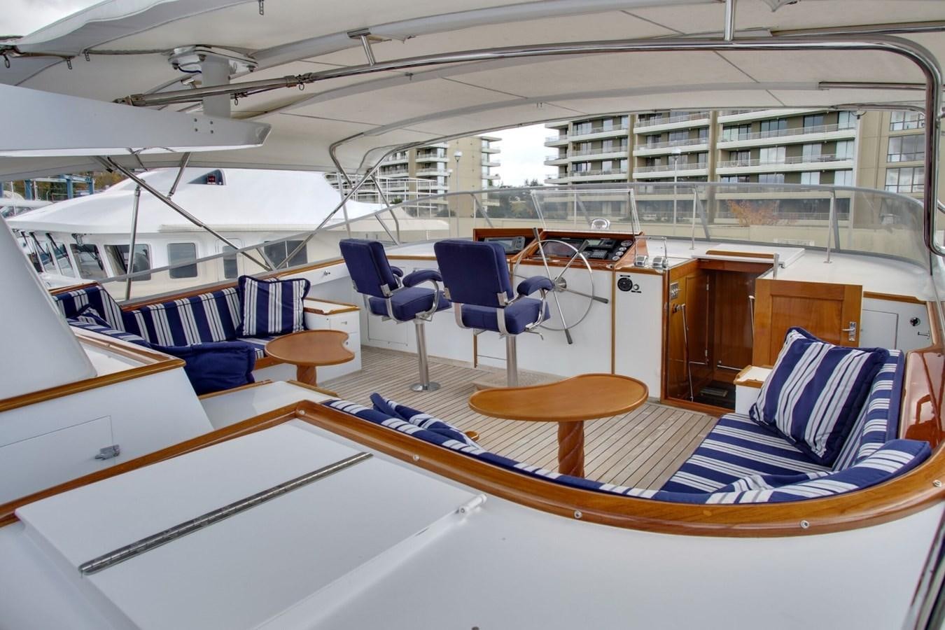 a room with a table chairs and a bed aboard ALEXIS Yacht for Sale