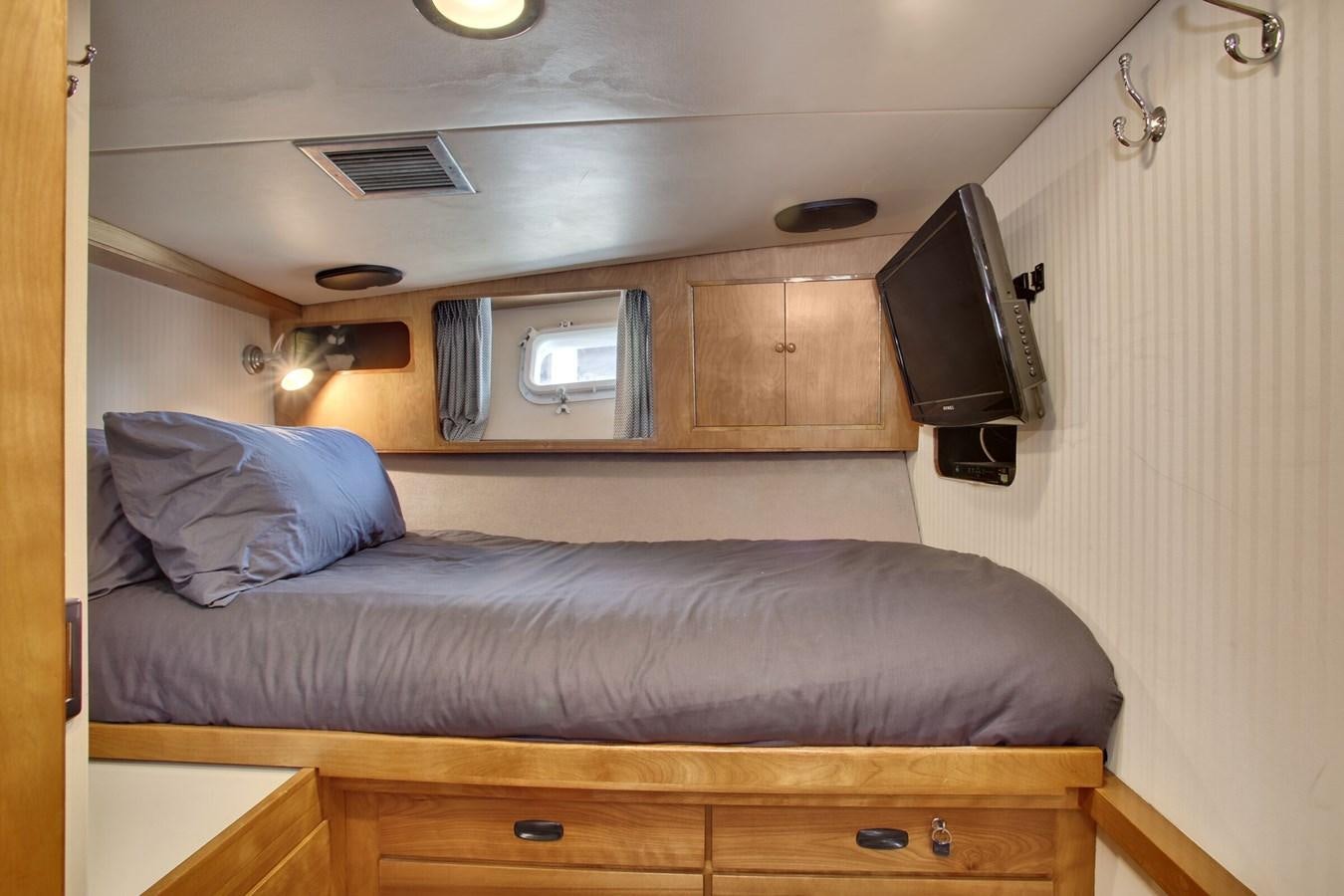 a bed with a television on top of it aboard ALEXIS Yacht for Sale