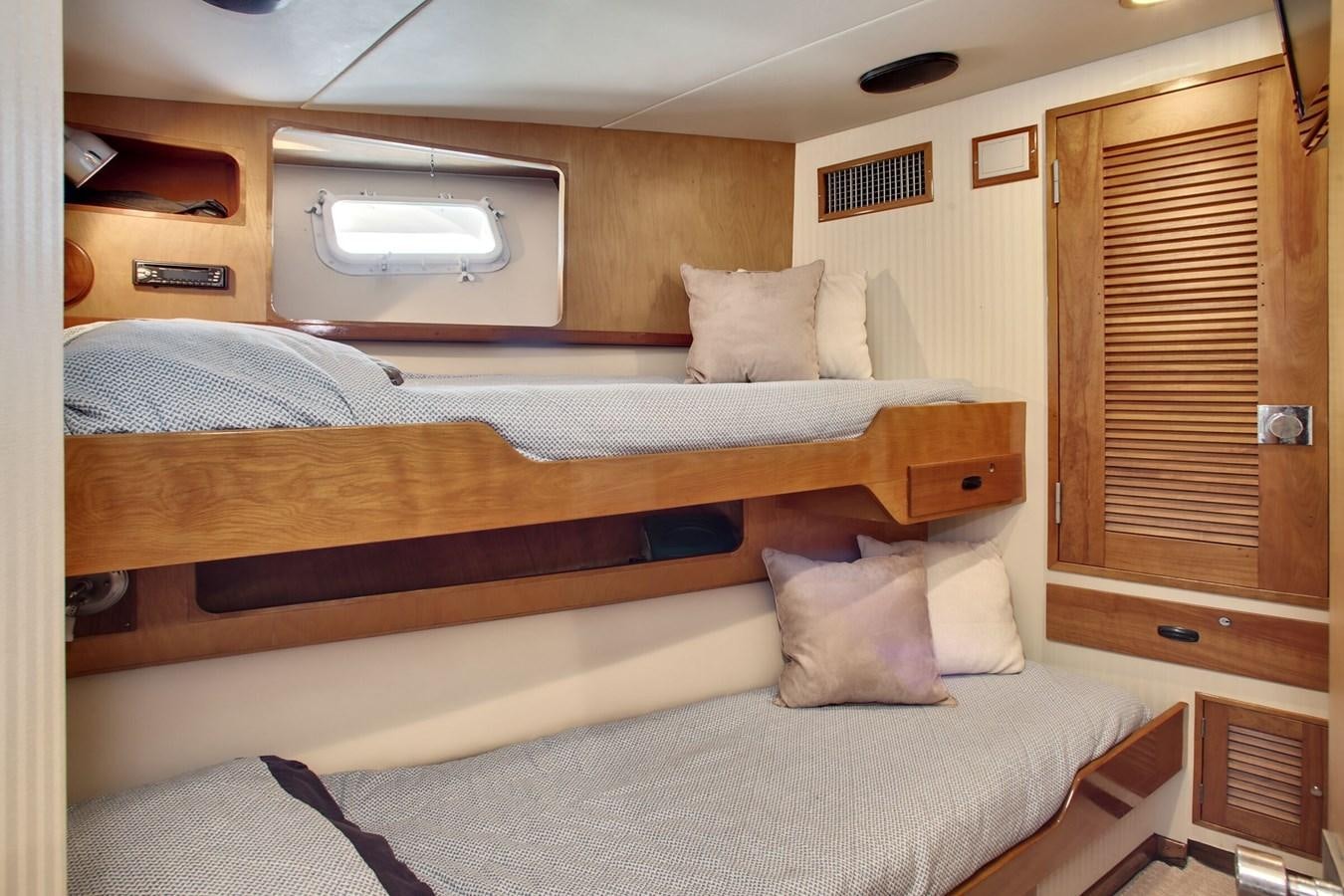 a bed with a wooden frame aboard ALEXIS Yacht for Sale